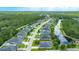 Aerial view of a neighborhood featuring a house with mature trees and a long lake in the background at 32 Abacus Ave, Ormond Beach, FL 32174