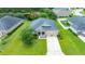 Aerial view of a single Gathering home with manicured lawn, large driveway, and stone archway entry at 32 Abacus Ave, Ormond Beach, FL 32174