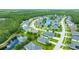 Aerial view highlighting a suburban neighborhood near a lush forest and a tranquil lake at 32 Abacus Ave, Ormond Beach, FL 32174