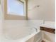 Close up of the white garden tub featuring chrome water fixtures and natural light at 32 Abacus Ave, Ormond Beach, FL 32174