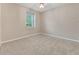 Comfortable bedroom with neutral carpet, a window for natural light, and a ceiling fan at 32 Abacus Ave, Ormond Beach, FL 32174