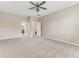 Bright bedroom featuring neutral carpet and paint and two door ways to other rooms in the house at 32 Abacus Ave, Ormond Beach, FL 32174