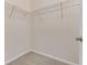 Main bedroom walk-in closet with built in wire shelving and carpet floors at 32 Abacus Ave, Ormond Beach, FL 32174
