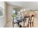 Dining room with tile floors and statement lighting, offering views of the backyard at 32 Abacus Ave, Ormond Beach, FL 32174