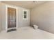 A covered front entryway features a welcome mat, a dark front door with sidelight, and textured stucco walls at 32 Abacus Ave, Ormond Beach, FL 32174