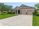 Charming single-story home featuring a stone accented facade, well-manicured lawn, and a spacious two car garage at 32 Abacus Ave, Ormond Beach, FL 32174