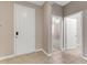 Home foyer with white entry door, neutral walls, ceramic tile flooring, and views to other rooms at 32 Abacus Ave, Ormond Beach, FL 32174