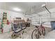 Two car garage with storage racks and concrete flooring at 32 Abacus Ave, Ormond Beach, FL 32174