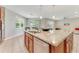 Kitchen island with seating, granite countertops, stainless steel appliances, and lots of natural light at 32 Abacus Ave, Ormond Beach, FL 32174