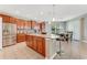 Stylish kitchen with stainless steel appliances, granite countertops, breakfast bar seating, and rich wood cabinetry at 32 Abacus Ave, Ormond Beach, FL 32174