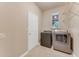Tile laundry room featuring a new washer and dryer and a window at 32 Abacus Ave, Ormond Beach, FL 32174