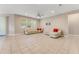 Spacious living room with tile floors, neutral walls, ceiling fan, and bright natural light at 32 Abacus Ave, Ormond Beach, FL 32174