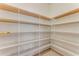 Walk-in pantry with adjustable metal shelving for optimal storage, and tile floor at 32 Abacus Ave, Ormond Beach, FL 32174