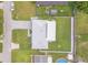 Overhead view of a well-maintained house, long driveway and fenced backyard with lush lawn at 3324 Royal Palm Dr, Edgewater, FL 32141