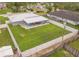 Aerial view of the large, fenced backyard with a covered patio and ample green space at 3324 Royal Palm Dr, Edgewater, FL 32141
