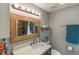 Bathroom features a wide mirror over the sink and a decorative wooden frame at 3324 Royal Palm Dr, Edgewater, FL 32141
