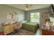 Charming bedroom with desk area, wood-look floors, a ceiling fan, natural light, and neutral paint at 3324 Royal Palm Dr, Edgewater, FL 32141