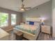 Cozy bedroom featuring wood-look floors, abundant natural light, a ceiling fan, and neutral paint at 3324 Royal Palm Dr, Edgewater, FL 32141