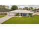 Charming single-story home with a well-manicured lawn, brick driveway, and attached garage at 3324 Royal Palm Dr, Edgewater, FL 32141