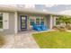 Welcoming front porch with vibrant blue seating and a beautifully landscaped walkway at 3324 Royal Palm Dr, Edgewater, FL 32141