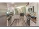 Well-appointed kitchen featuring granite countertops, stainless steel appliances, modern white cabinets and wood-look floors at 3324 Royal Palm Dr, Edgewater, FL 32141