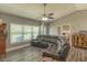 Comfortable living room featuring neutral paint, wood-look floors, a large window for natural light and vaulted ceiling at 3324 Royal Palm Dr, Edgewater, FL 32141