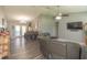 Bright living room with vaulted ceilings, wood-look floors, an inviting atmosphere and easy flow to dining area at 3324 Royal Palm Dr, Edgewater, FL 32141