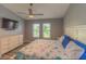 Relaxing bedroom featuring wood-look floors, neutral color palette, and a ceiling fan at 3324 Royal Palm Dr, Edgewater, FL 32141