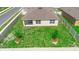 Aerial view of a fenced backyard featuring a well-maintained lawn and patio, offering privacy and space at 33436 Shutterfly Way, Sorrento, FL 32776
