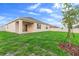 Expansive backyard featuring a well-maintained lawn, white fence, and young trees, offering privacy and space at 33436 Shutterfly Way, Sorrento, FL 32776