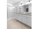 Contemporary bathroom featuring a glass-enclosed shower and a double vanity with ample counter space at 33436 Shutterfly Way, Sorrento, FL 32776