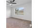 Comfortable bedroom featuring a ceiling fan and a window overlooking the outside at 33436 Shutterfly Way, Sorrento, FL 32776