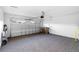 Spacious garage featuring neutral carpeting, an automatic door opener, and ample space for parking and storage at 33436 Shutterfly Way, Sorrento, FL 32776