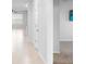 Bright hallway with neutral tile floors and a view into a spacious living area filled with natural light at 33436 Shutterfly Way, Sorrento, FL 32776