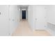 Well lit hallway with tile floors and neutral decor at 33436 Shutterfly Way, Sorrento, FL 32776