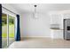 Bright eat-in kitchen featuring an island, stainless steel appliances, and sliding glass doors at 33436 Shutterfly Way, Sorrento, FL 32776