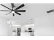 Open concept kitchen with modern stainless appliances and ceiling fan at 33436 Shutterfly Way, Sorrento, FL 32776