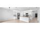 Open kitchen with an island, stainless steel appliances, and bright lighting at 33436 Shutterfly Way, Sorrento, FL 32776