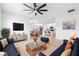 Bright and airy living room with tile floors, ceiling fan, and a view of the kitchen at 33436 Shutterfly Way, Sorrento, FL 32776