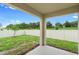 Covered patio overlooking a spacious, fenced backyard, perfect for outdoor living and entertaining at 33436 Shutterfly Way, Sorrento, FL 32776