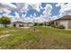 Spacious backyard featuring a pergola, fire pit, and well-maintained lawn, ideal for outdoor enjoyment at 3810 Arboreal Ct, Deland, FL 32724