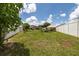 Expansive backyard features a privacy fence, lush grass, and mature trees, perfect for outdoor activities and relaxation at 3810 Arboreal Ct, Deland, FL 32724