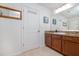 Bathroom featuring tile floors, wood vanity, granite counter, and framed mirror at 3810 Arboreal Ct, Deland, FL 32724