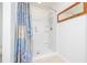 Bathroom with standing shower featuring shower head and blue patterned shower curtain at 3810 Arboreal Ct, Deland, FL 32724
