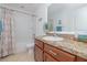 Well-lit bathroom featuring a shower-tub combination and vanity with attractive countertop at 3810 Arboreal Ct, Deland, FL 32724
