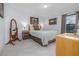 Bedroom with tile floors, natural light, neutral decor, and ensuite bathroom access at 3810 Arboreal Ct, Deland, FL 32724