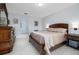 Cozy bedroom featuring neutral walls, tile flooring, and a comfortable bed at 3810 Arboreal Ct, Deland, FL 32724