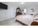 Bright bedroom features tile floors, neutral walls, and an ensuite bathroom at 3810 Arboreal Ct, Deland, FL 32724