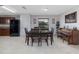 Dining room with tile flooring, dining table and chairs, piano, and black refrigerator at 3810 Arboreal Ct, Deland, FL 32724