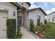 Inviting home entrance with neatly trimmed bushes, a welcoming front door, and decorative flower beds at 3810 Arboreal Ct, Deland, FL 32724